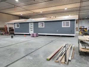 Side view of a modular home in Grand Forks with Hardie plank siding, preparing for asphalt shingle roof installation.