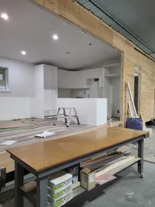 Kitchen cabinets being installed in a new Grand Forks home, showcasing progress in interior finishing.