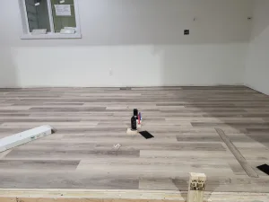 Natural earth-toned vinyl plank flooring in the master bedroom of a new home in Grand Forks, BC.